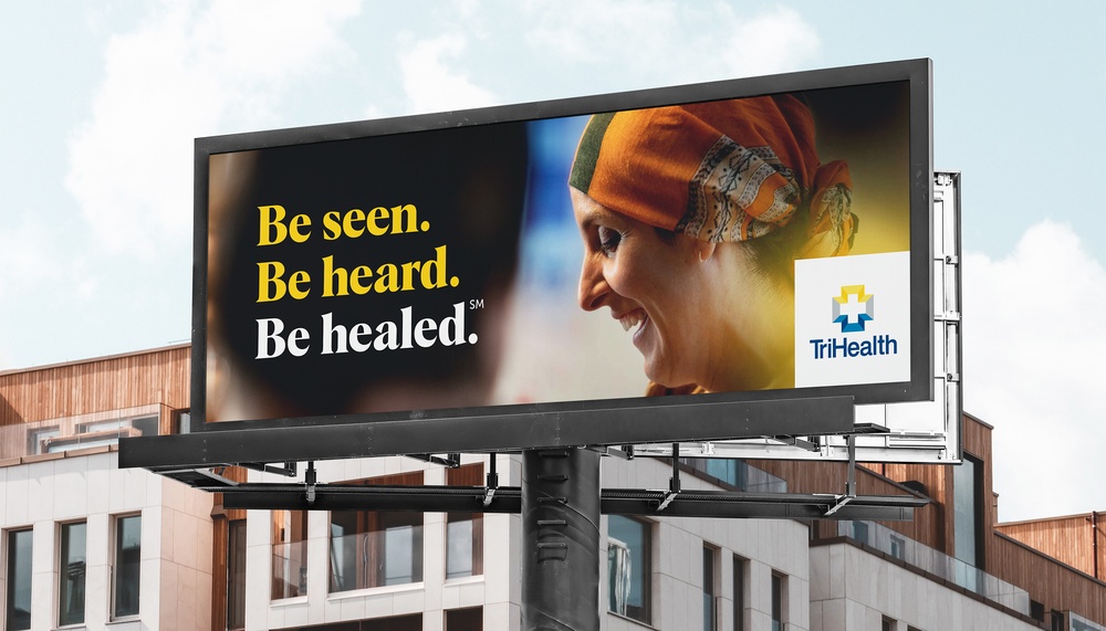 billboard with the words be seen be heard be healed and photo of a cancer survivor